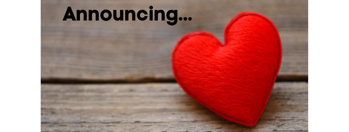 Red felted heart sits on wood background. Text reads: “Announcing…”